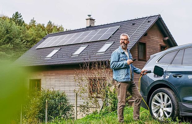 Mann beim Aufladen seines Autos