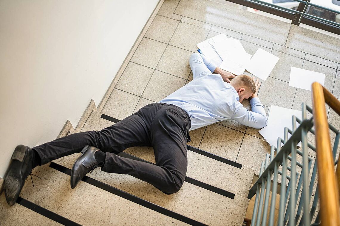 Ein Mann beim Sturz im Stiegenhaus